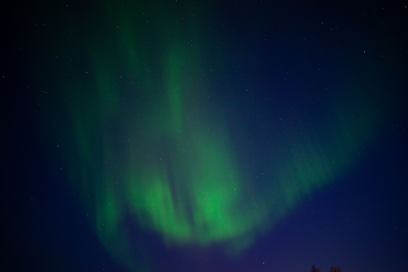 Green northern lights reflecting on Lake Superior at Pukaskwa National Park