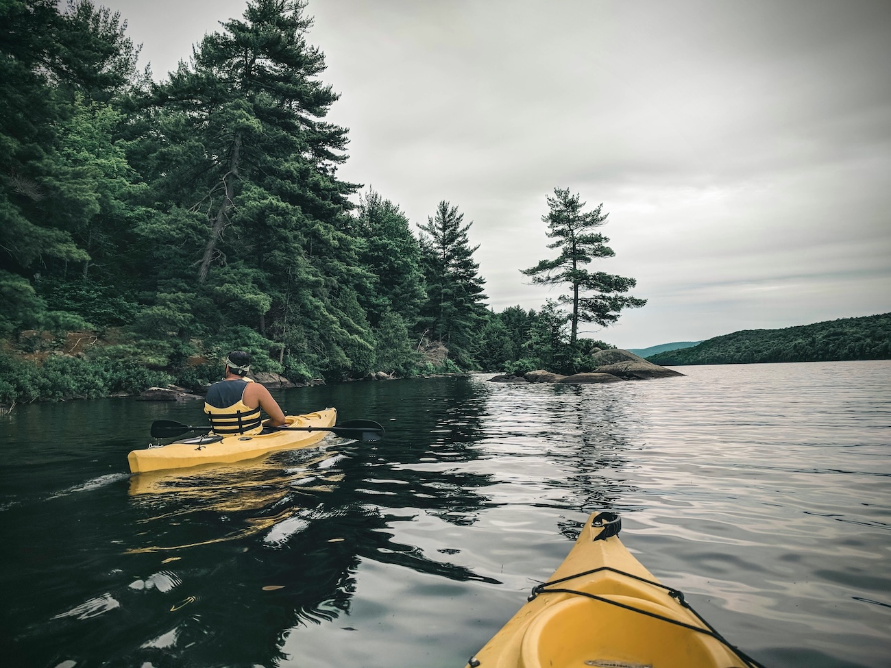 Kayaking on quiet bay in Muskoka Ontario at sunrise